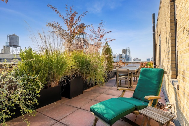 view of patio / terrace with outdoor dining area and a city view