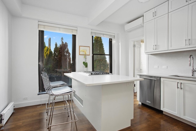 kitchen featuring dark wood finished floors, a baseboard radiator, appliances with stainless steel finishes, a wall mounted air conditioner, and a sink