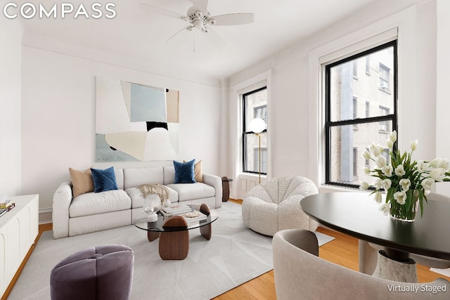 living room featuring hardwood / wood-style floors and ceiling fan