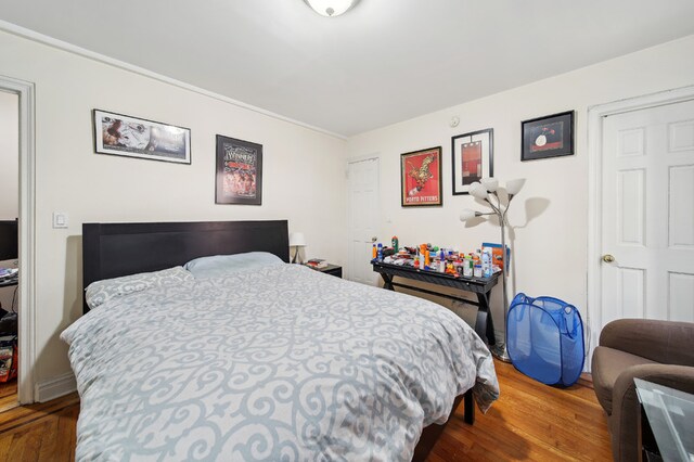 142 E 49th St Unit 3D, New York City, NY 10017 - bedroom featuring wood finished floors