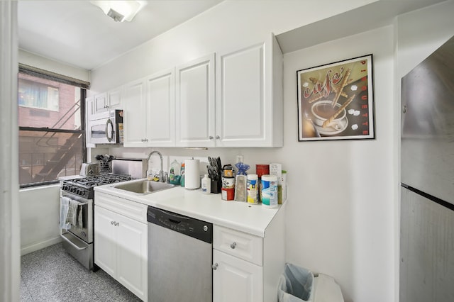 142 E 49th St Unit 3D, New York City, NY 10017 - kitchen featuring appliances with stainless steel finishes, a sink, white cabinetry, and light countertops