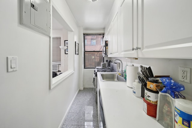 142 E 49th St Unit 3D, New York City, NY 10017 - laundry area with granite tiled floors, baseboards, electric panel, a sink, and cooling unit