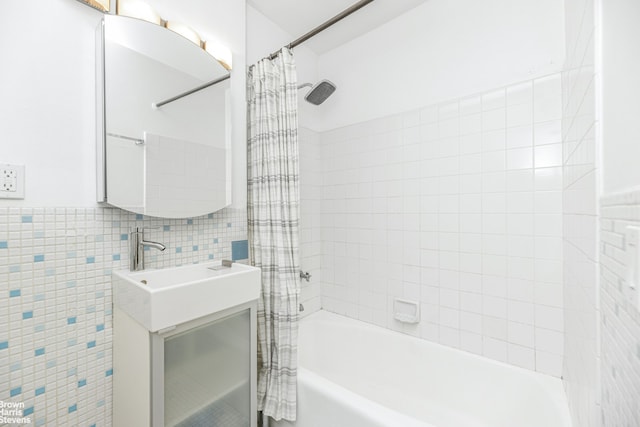 full bath featuring tile walls, shower / bathtub combination with curtain, and vanity