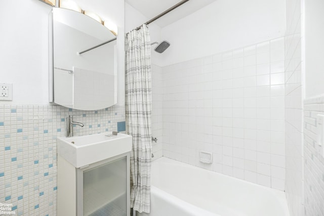 bathroom with tile walls, vanity, and shower / bath combo with shower curtain