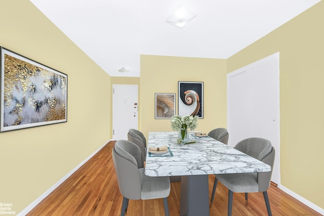 dining area featuring baseboards and wood finished floors