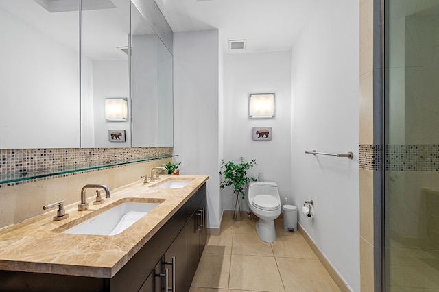 full bathroom featuring tile patterned floors, toilet, tasteful backsplash, and a sink