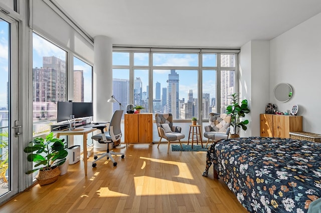 bedroom featuring light hardwood / wood-style flooring and expansive windows