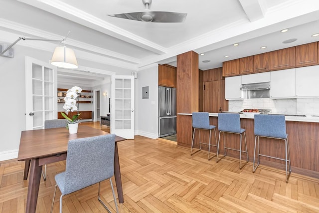 kitchen with white cabinetry, high end fridge, backsplash, light parquet flooring, and french doors