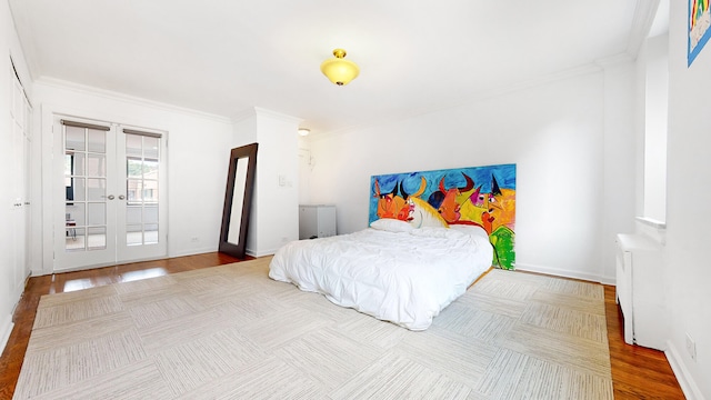 bedroom with crown molding, french doors, wood finished floors, radiator, and baseboards
