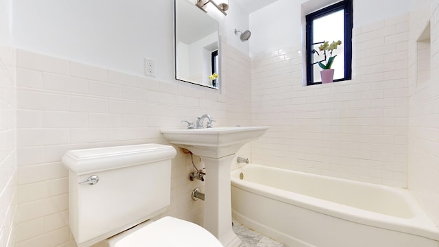 full bathroom with tile walls, toilet, and shower / tub combination