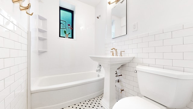 full bath with tile walls, toilet, and shower / tub combination