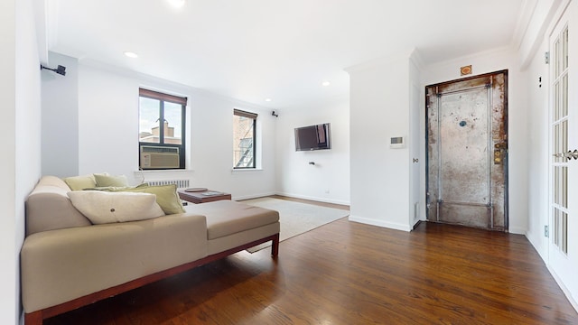 living room featuring wood finished floors, baseboards, recessed lighting, ornamental molding, and cooling unit