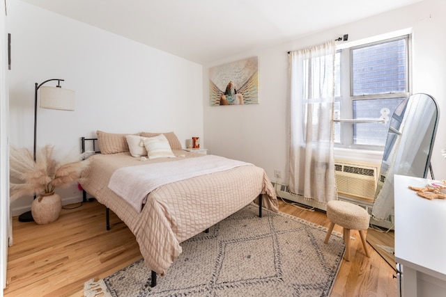 bedroom featuring light hardwood / wood-style floors and multiple windows