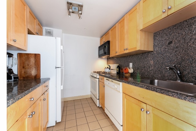 kitchen with white appliances, dark stone counters, decorative backsplash, sink, and light tile patterned flooring