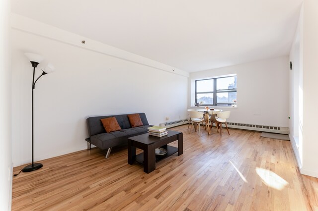 1831 Madison Ave Unit 9-F, New York City, NY 10035 - living area with light wood-type flooring, a baseboard radiator, and baseboard heating