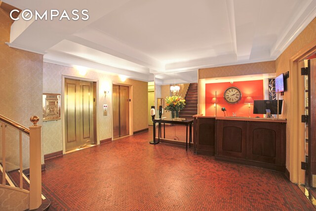 reception featuring stairway and a dry bar