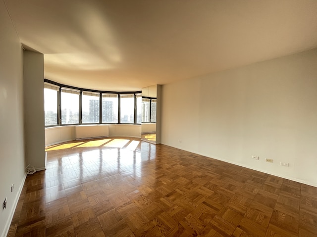 empty room featuring parquet flooring