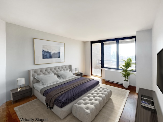 bedroom featuring dark parquet floors and radiator heating unit