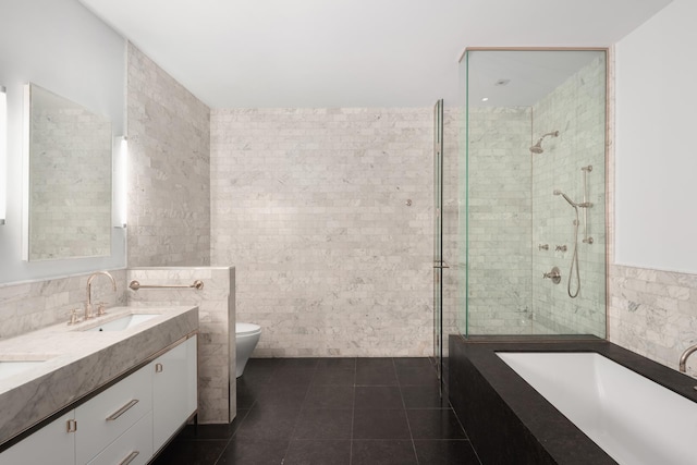 full bathroom with tile walls, a stall shower, tile patterned flooring, toilet, and a bathtub