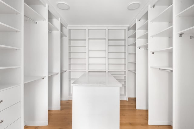 walk in closet with light wood-type flooring