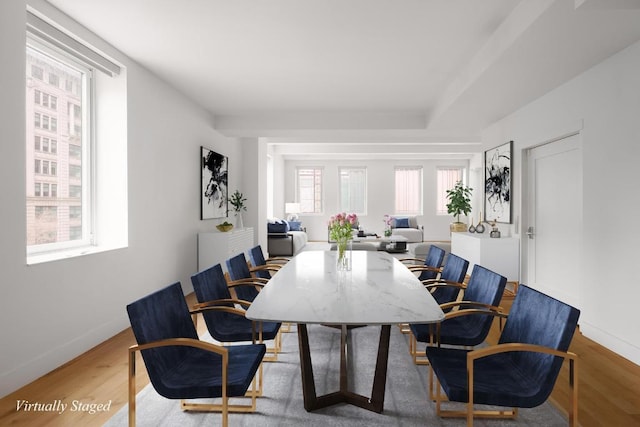 dining space with wood-type flooring