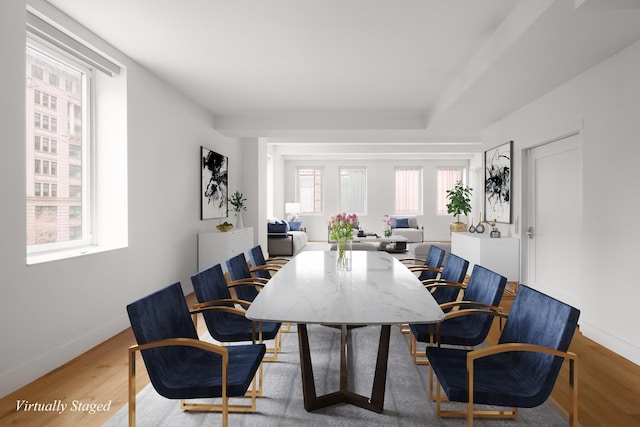 dining space featuring wood finished floors and baseboards