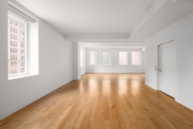 spare room with light wood-type flooring and baseboards