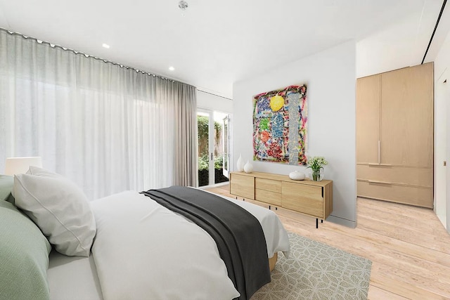 bedroom with access to outside and light wood-type flooring