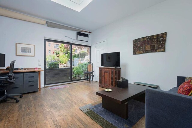 living room featuring dark wood-type flooring and built in shelves