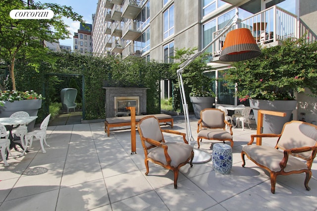 view of patio / terrace featuring exterior fireplace