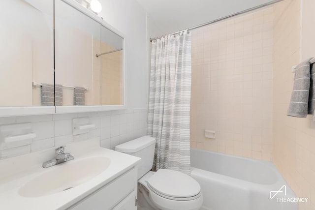 full bathroom featuring vanity, tile walls, shower / bathtub combination with curtain, and toilet