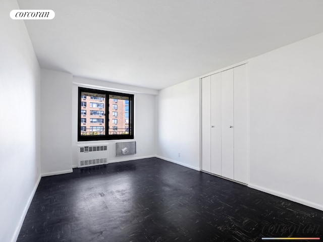 unfurnished room featuring radiator