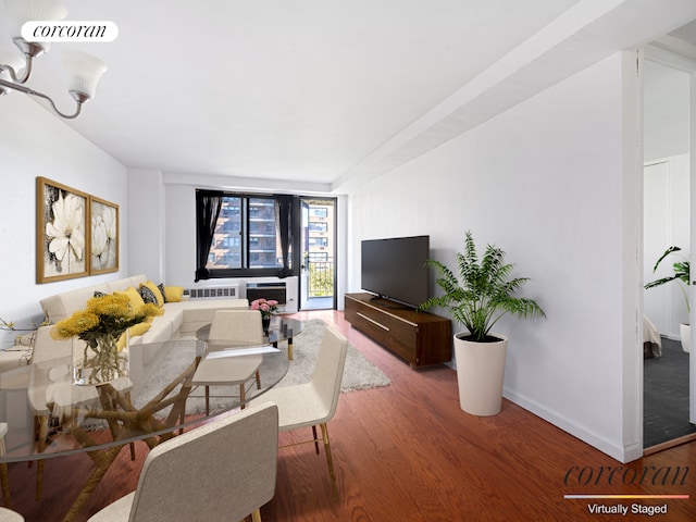 living area featuring wood finished floors, visible vents, and baseboards