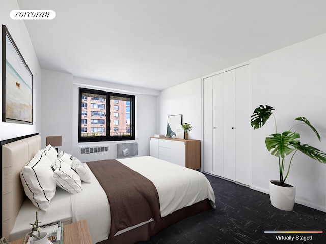 bedroom with a closet, visible vents, and radiator heating unit