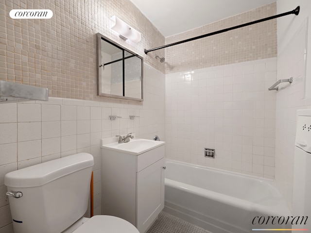 bathroom featuring shower / tub combination, tile walls, toilet, and vanity