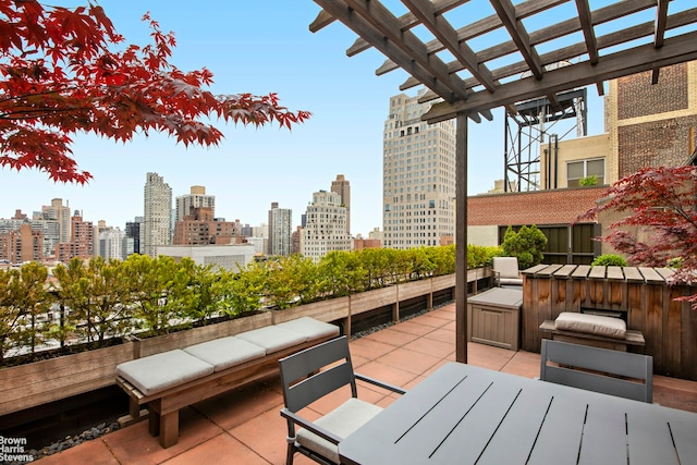 view of patio featuring a city view and outdoor dining area