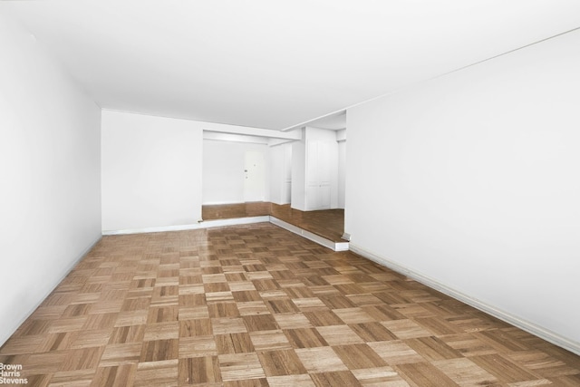 unfurnished room with light parquet flooring