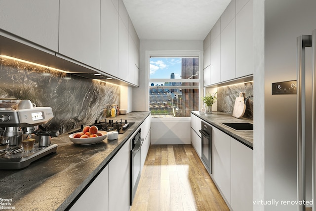 kitchen featuring black oven, white cabinets, modern cabinets, and wall oven