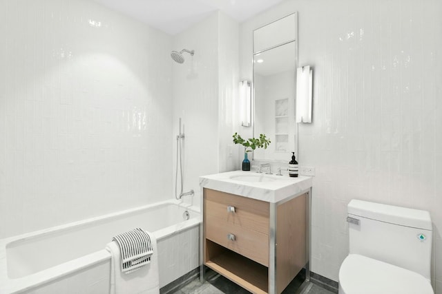 full bathroom featuring toilet, tiled shower / bath combo, and vanity