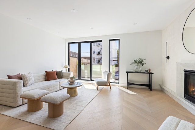 living room featuring light parquet flooring and a fireplace