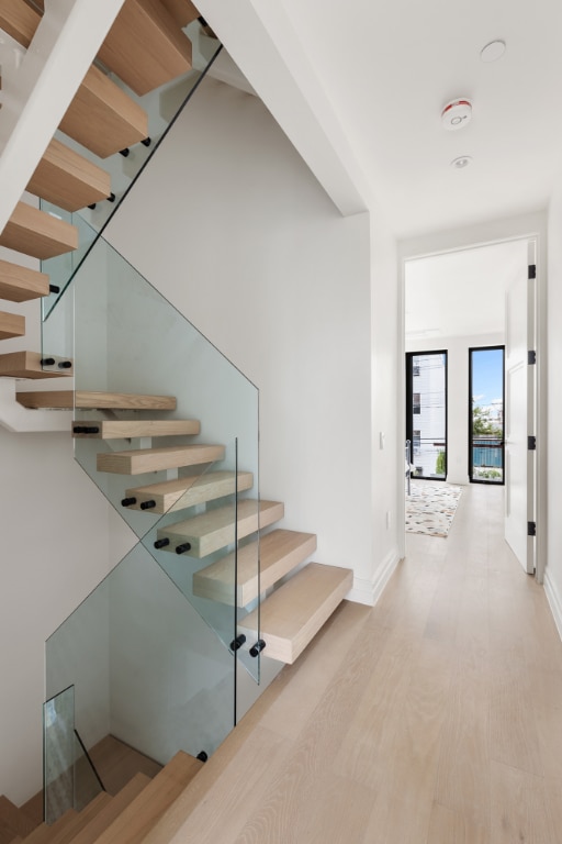 stairs with hardwood / wood-style flooring