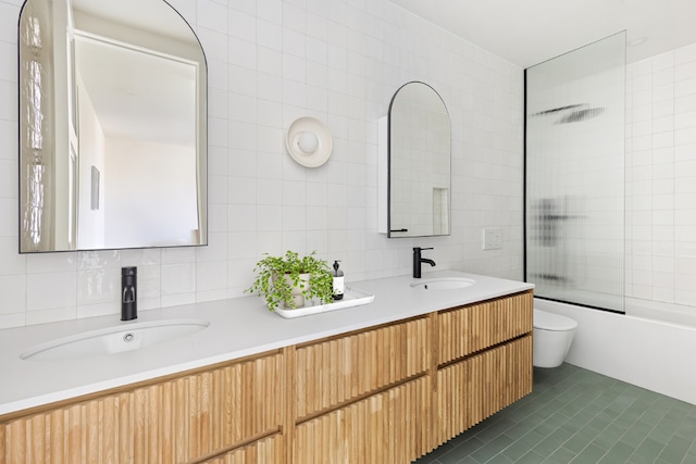 full bathroom with tile walls, tasteful backsplash, and bath / shower combo with glass door