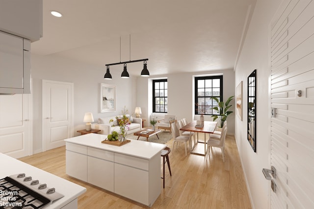 35 W 9th St Unit 1B, New York City, NY 10011 - kitchen with light wood-style floors, recessed lighting, open floor plan, a center island, and white cabinetry