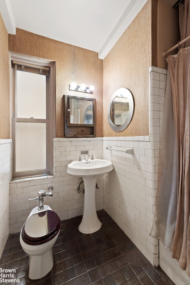 35 W 9th St Unit 1B, New York City, NY 10011 - bathroom with tile walls, healthy amount of natural light, tile patterned floors, a wainscoted wall, and a shower with shower curtain
