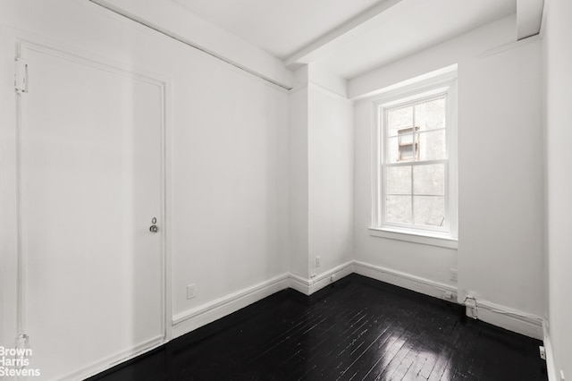 spare room with hardwood / wood-style flooring and plenty of natural light