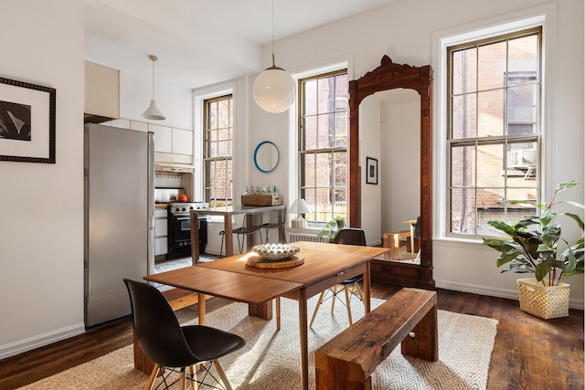 dining area featuring wood finished floors and baseboards