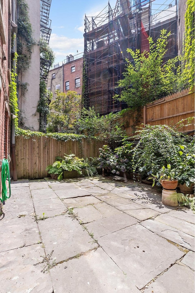 view of patio featuring fence