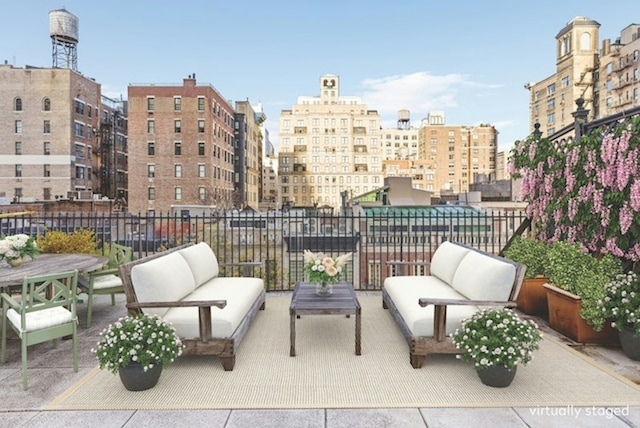 view of patio / terrace featuring an outdoor hangout area and a city view