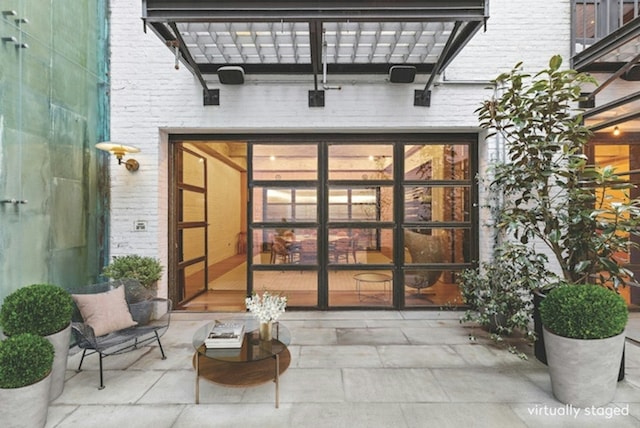 entrance to property featuring brick siding