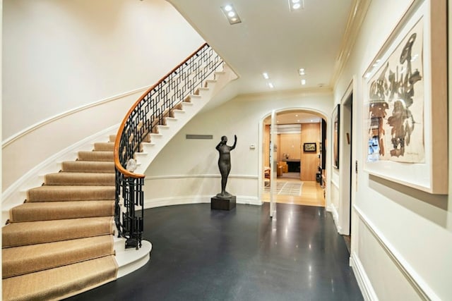 doorway featuring light hardwood / wood-style flooring and ornamental molding